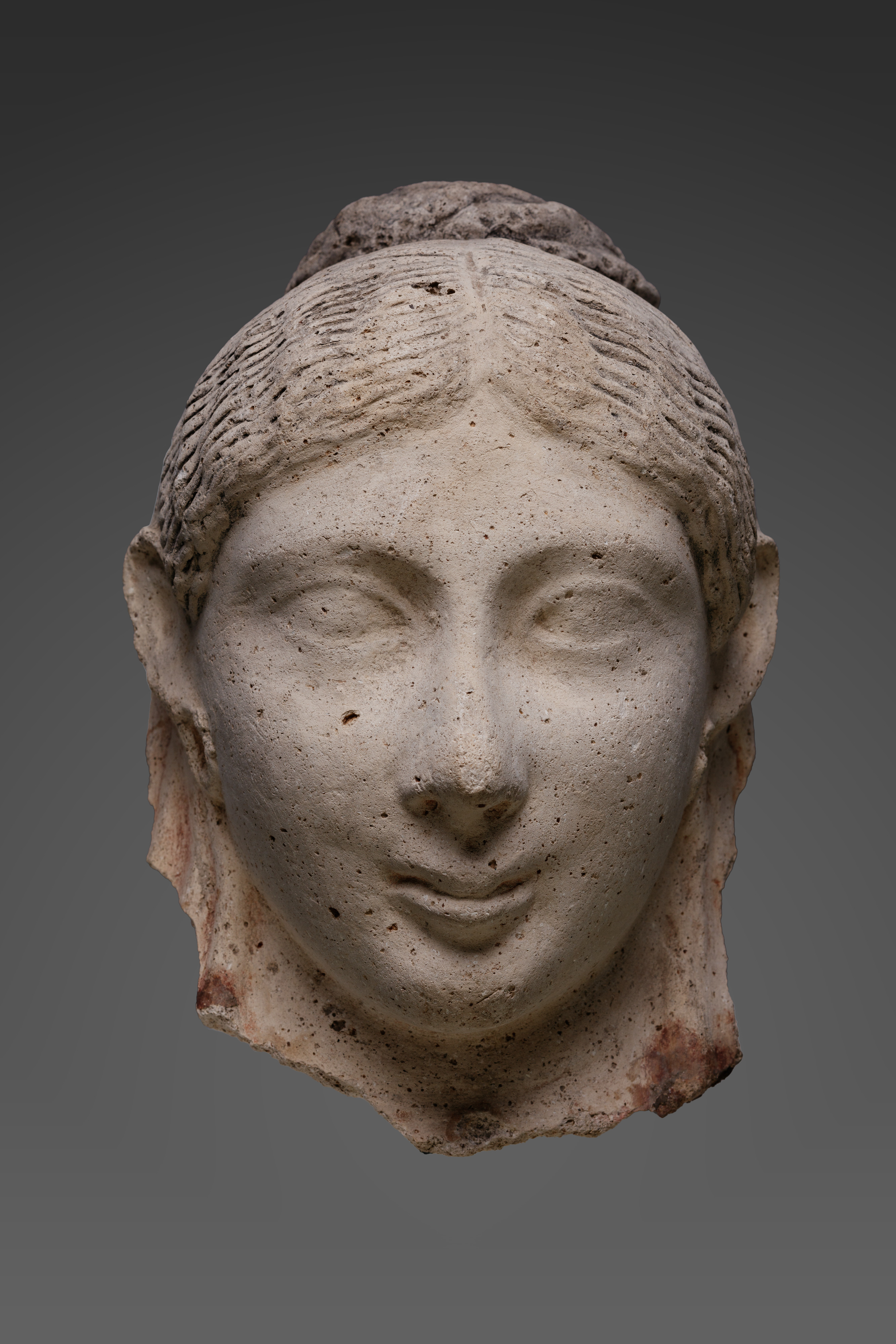 Mask of a woman with an austere hairstyle