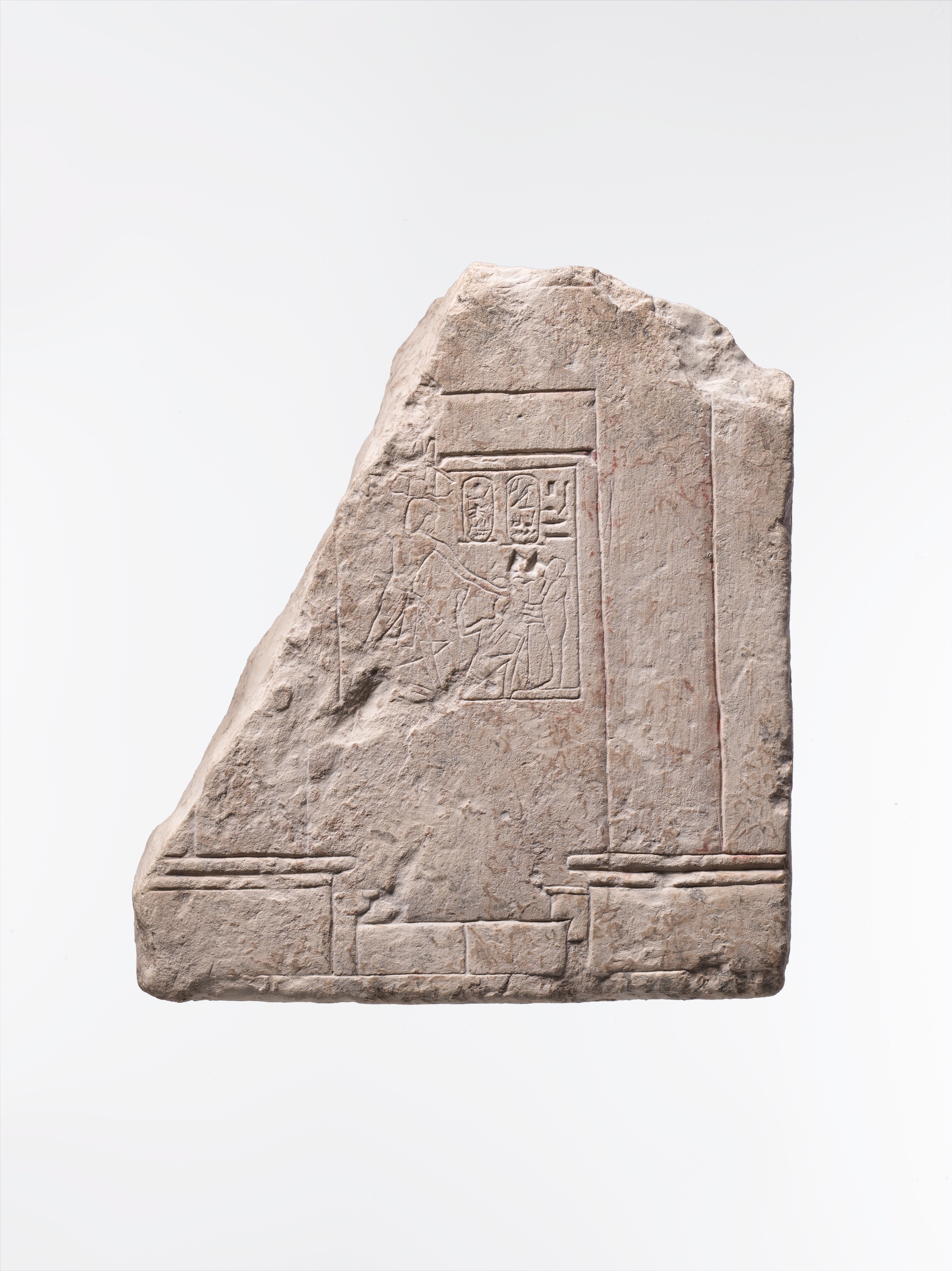 Relief showing part of a temple of Ptah with Haremhab smiting an enemy in front of the god
