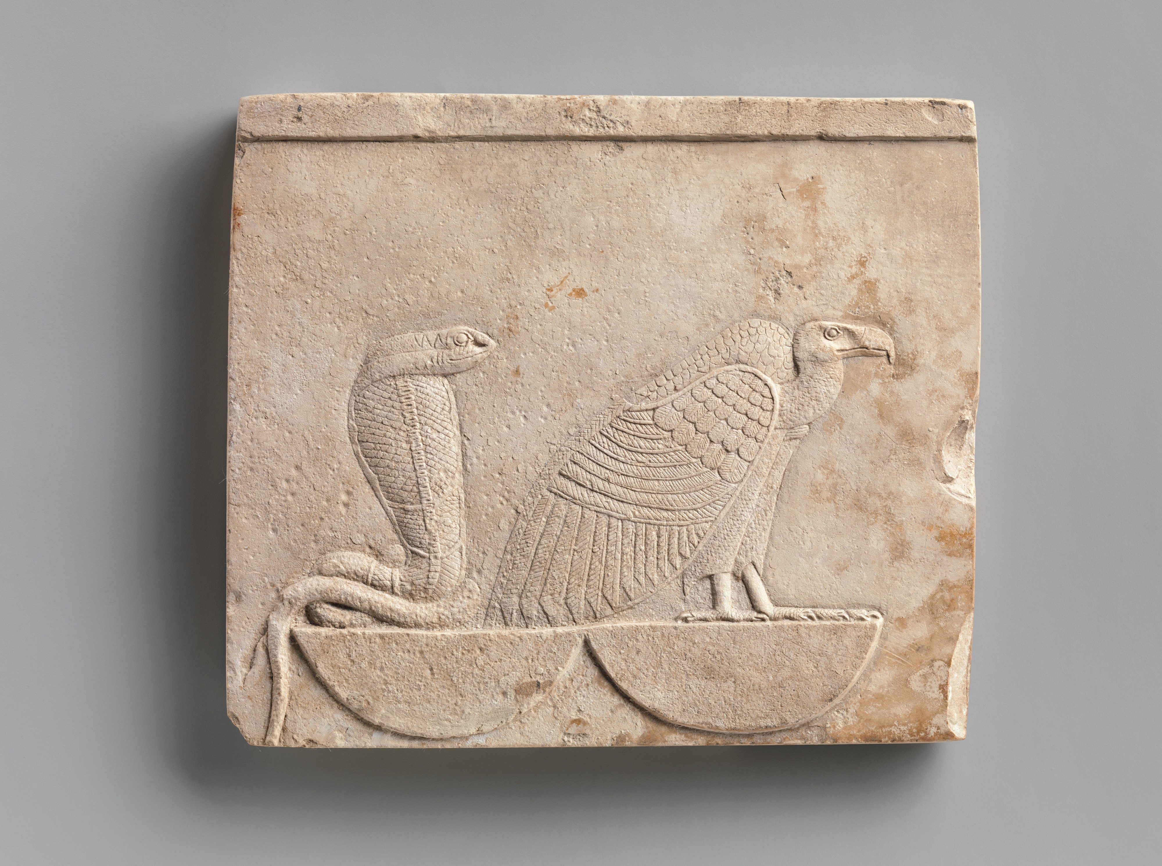 Relief  plaque with Wadjet and Nekhbet, the "Two Ladies"; falcon on opposite