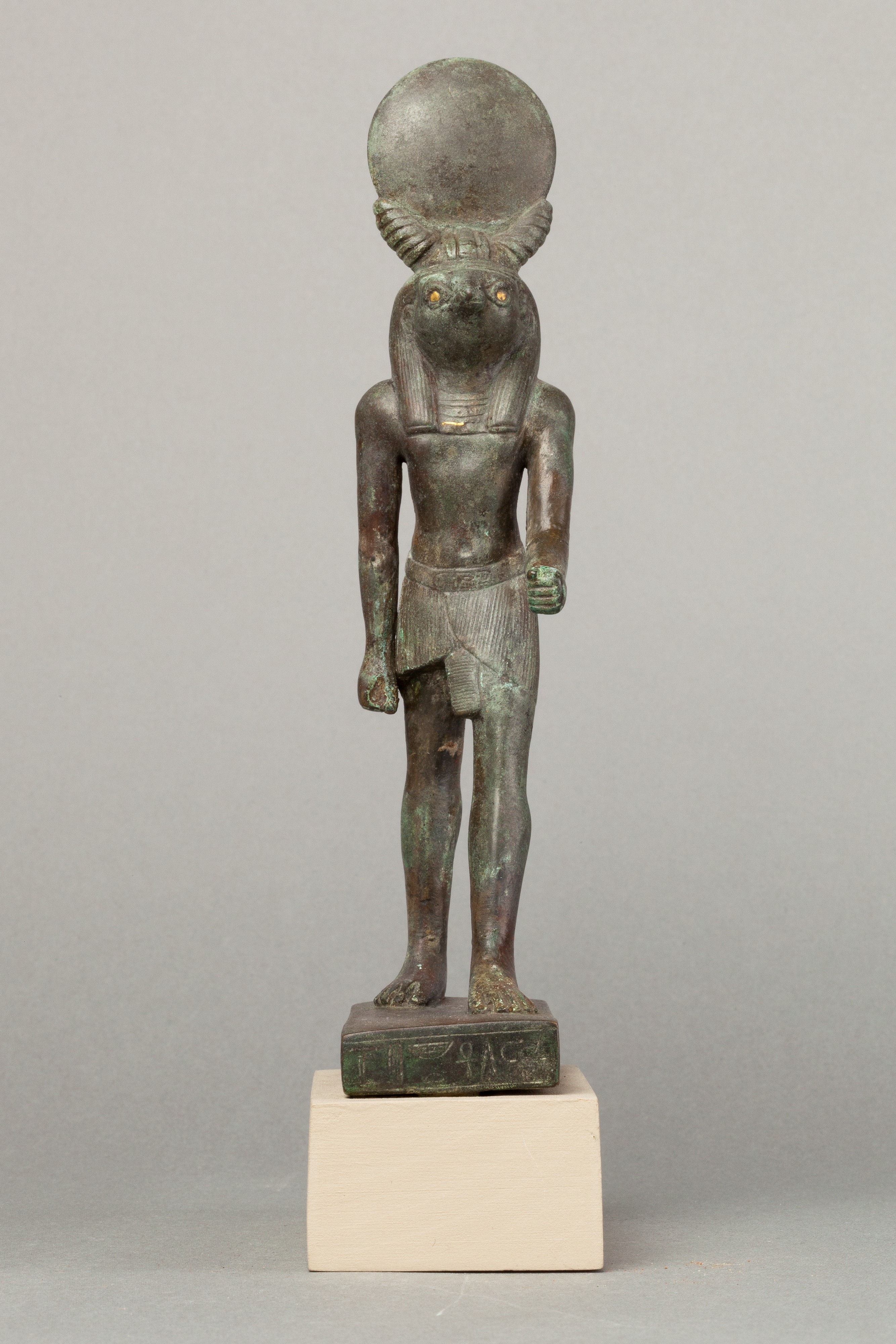 An ancient base asking blessings from Heka for the Scribe of the Library of Atum Pa-kap, son of the Prophet of Atum Pa-iry-kap and the mistress of the House Hr-ib-Wadjet; statue modern above the ankles