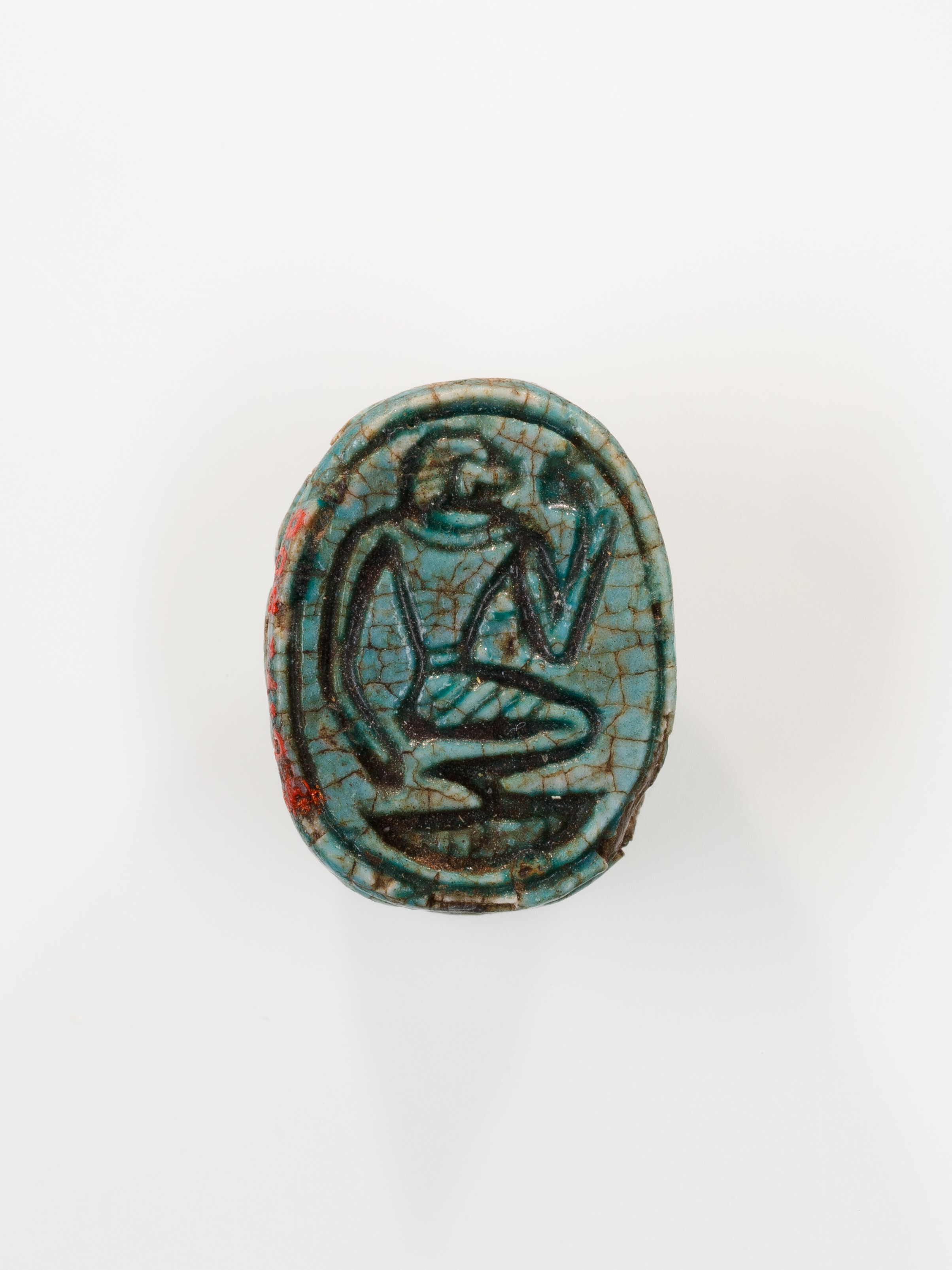 Scarab depicting a kneeling man (?)