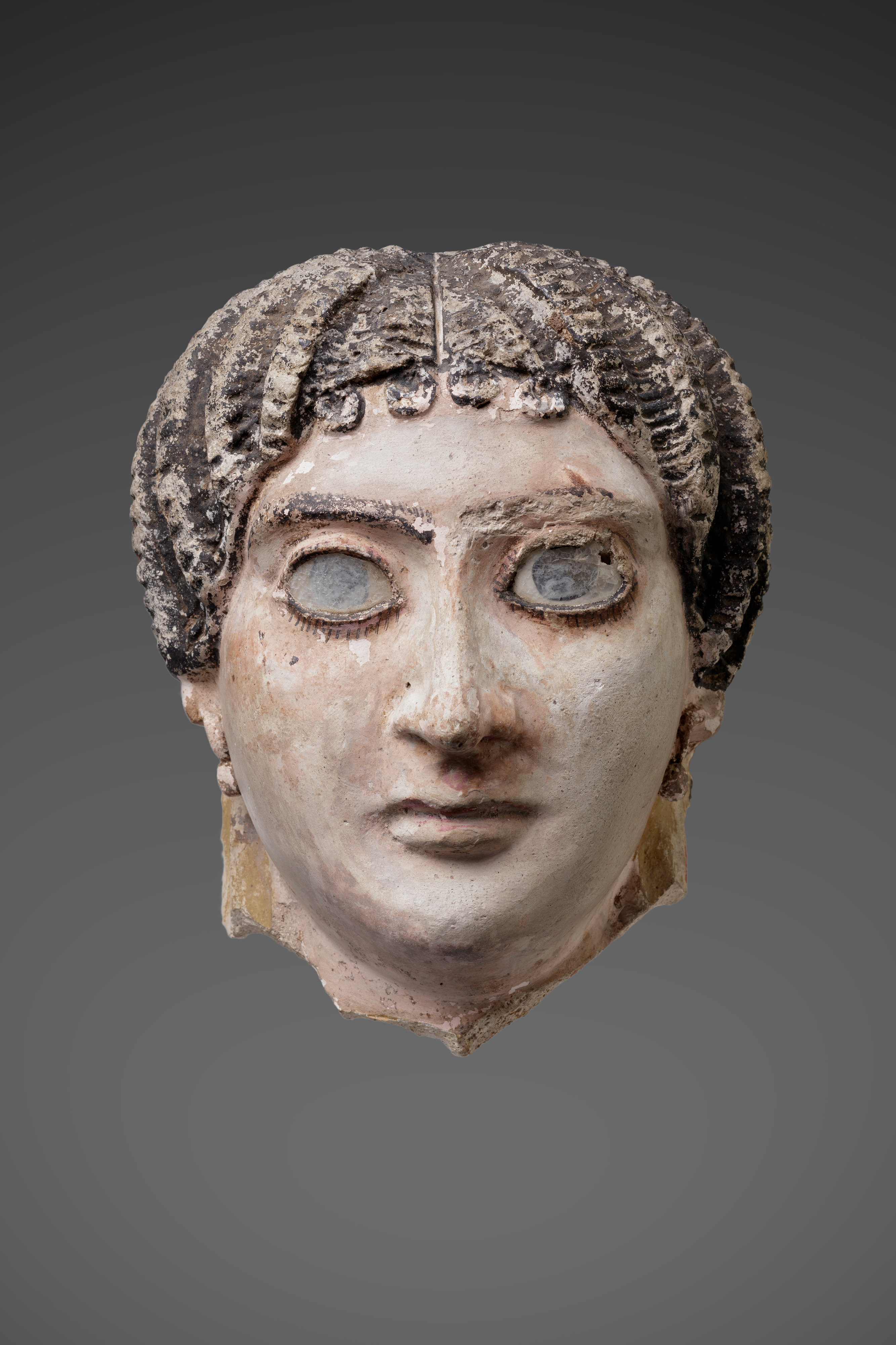 Mask of a woman with radiating waves of hair