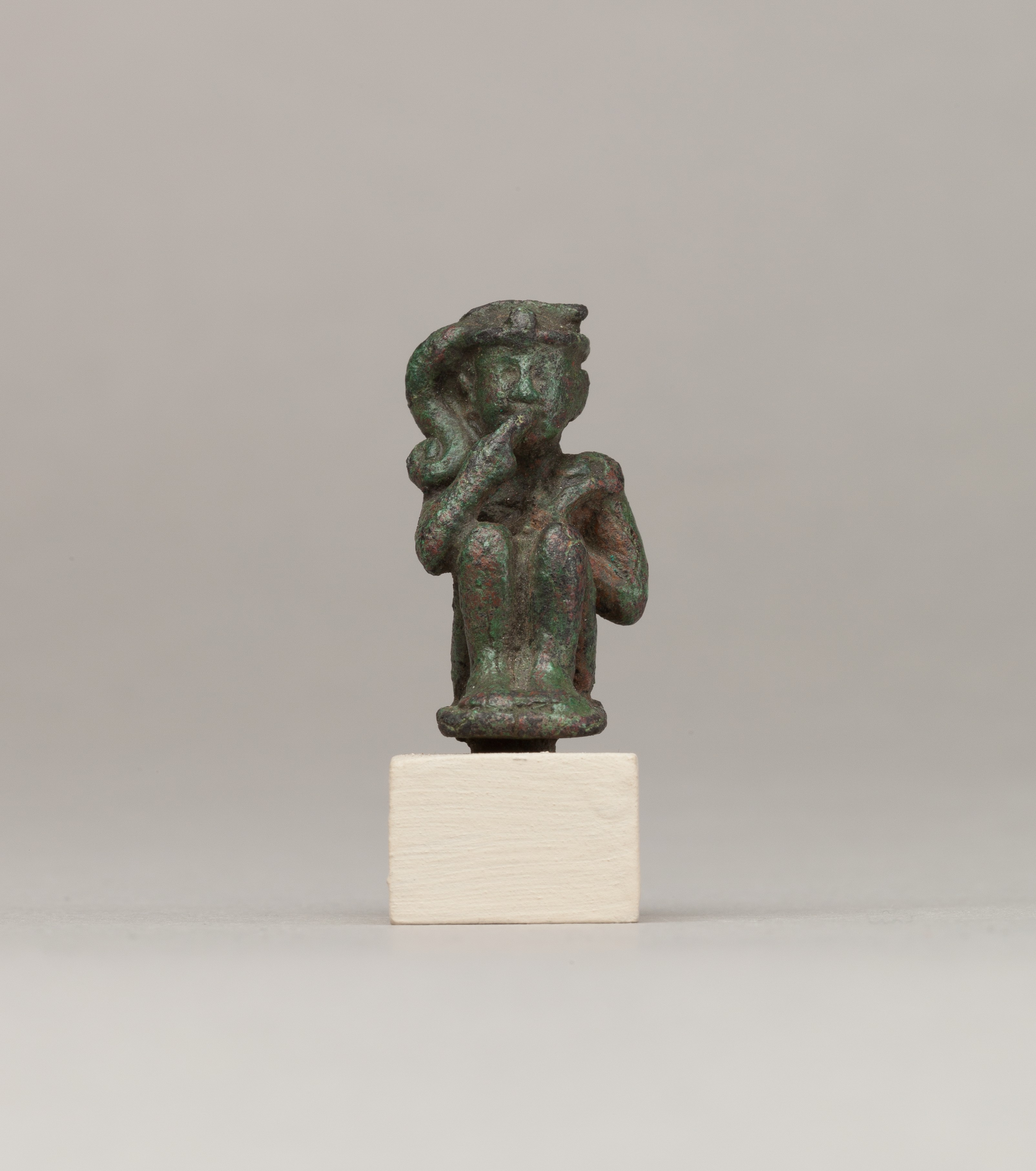 Crouching child god holding scepter