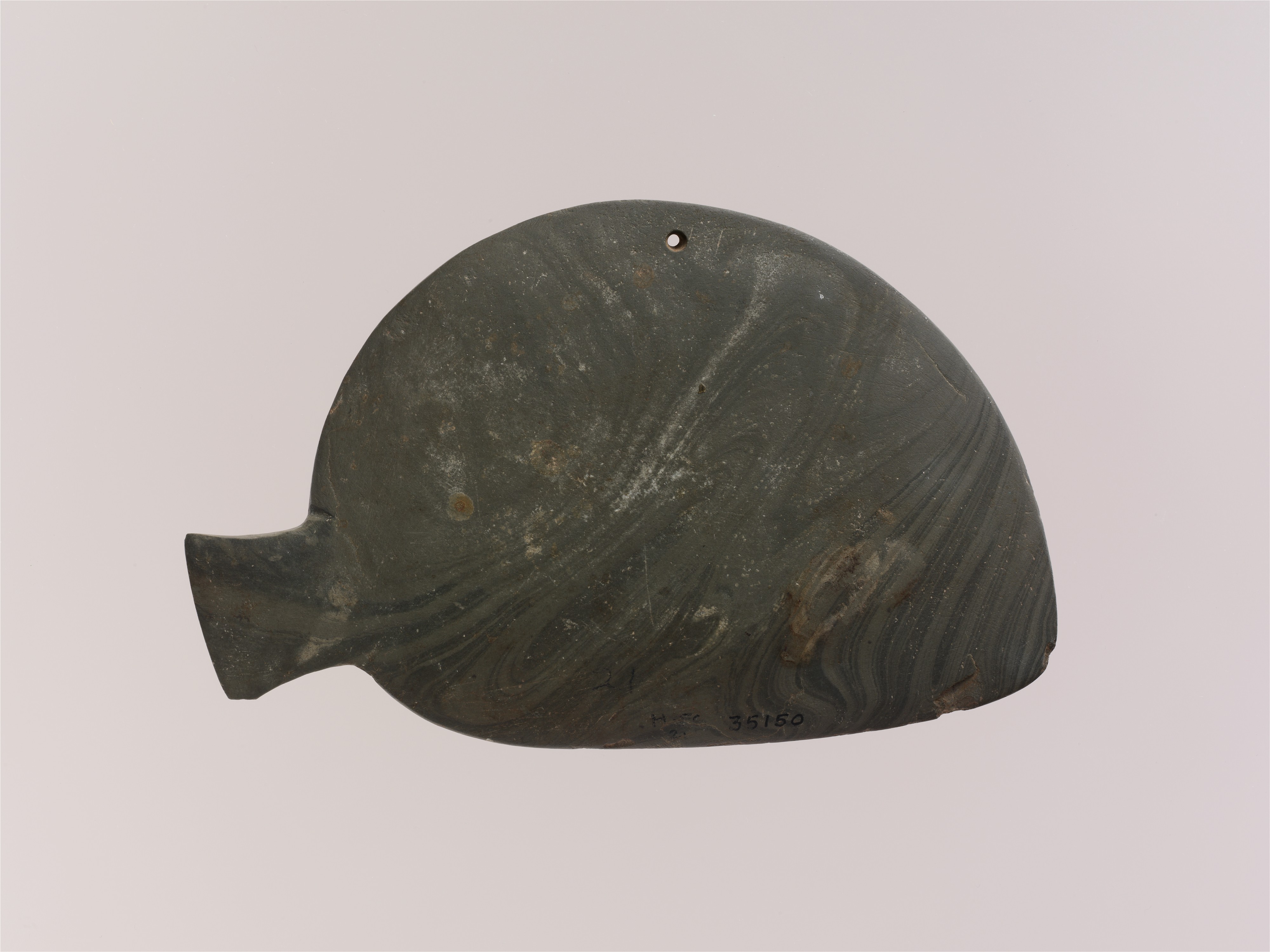 Fish-shaped palette with the remains of green pigment