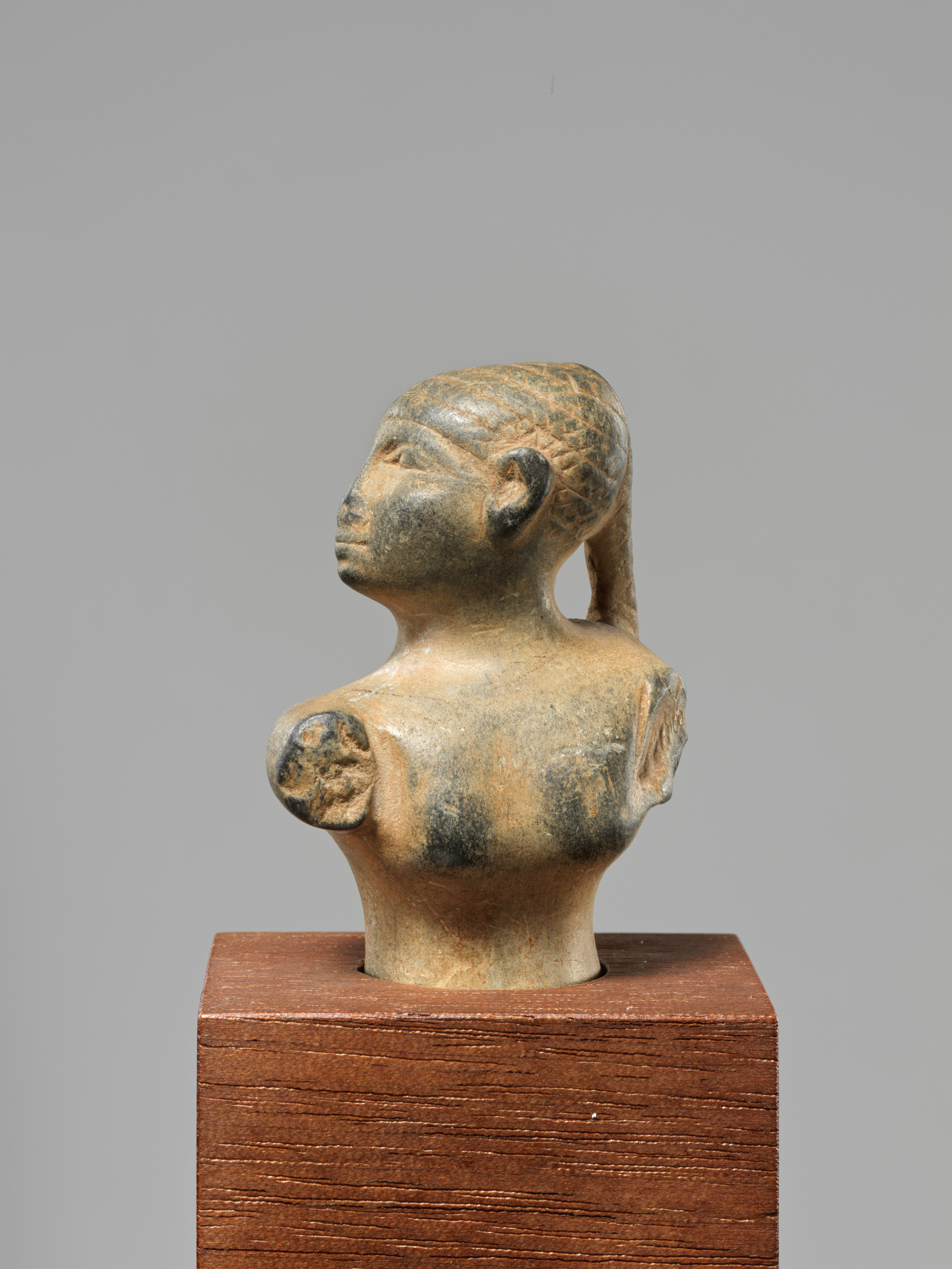 Statuette of a female figure with a braid