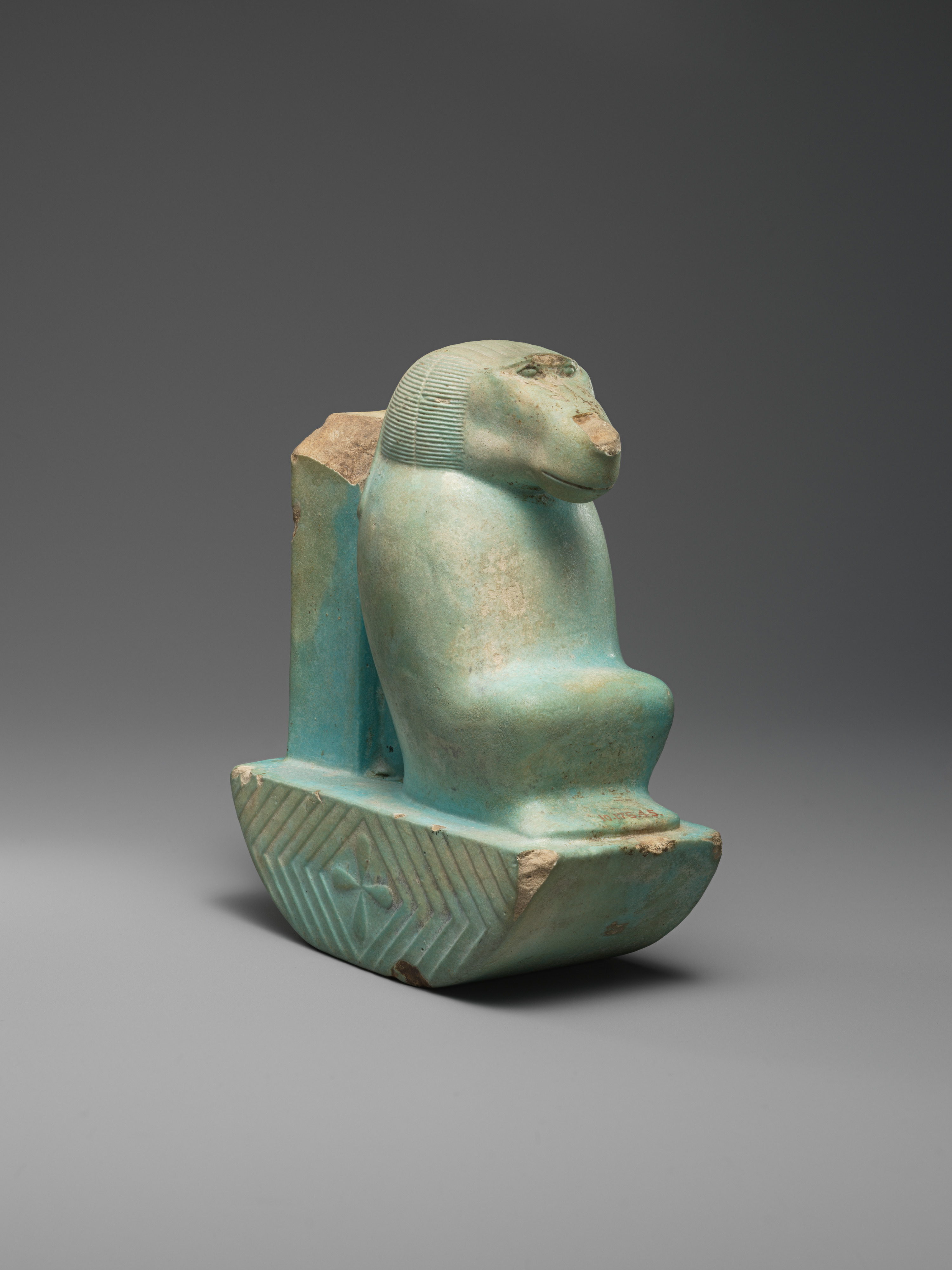 Figure of baboon on a basket and with a pillar (<em>shebet</em> offering)