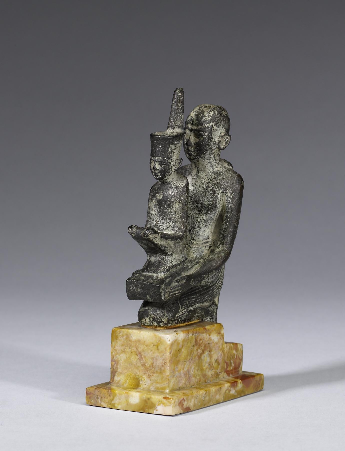 Priest Holding a Statue of the Goddess Neith