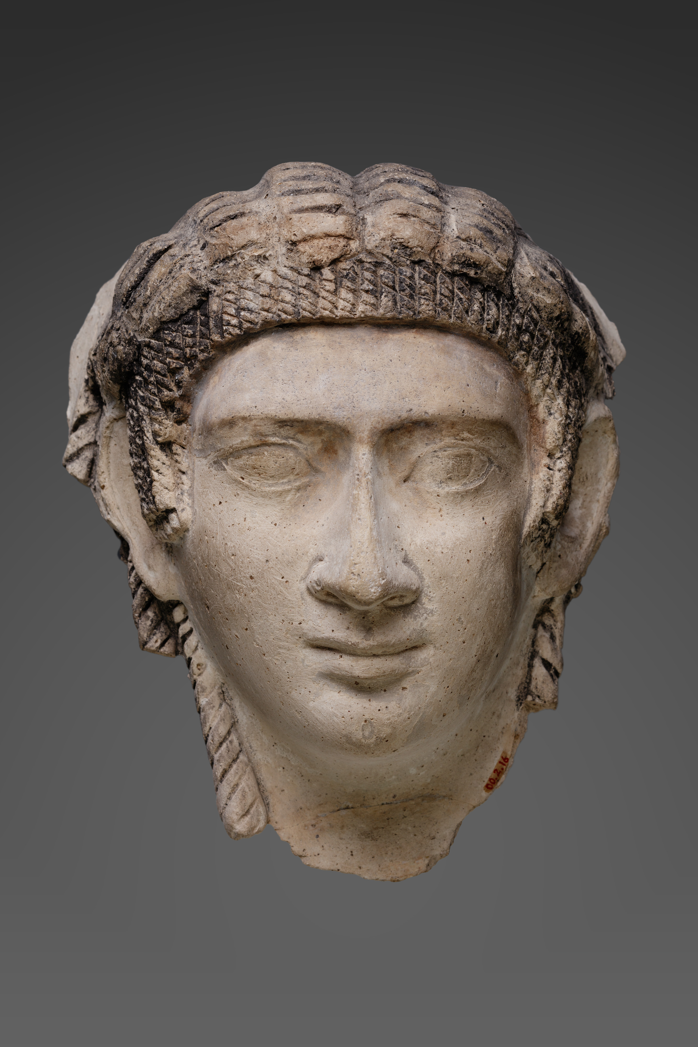 Mask of a woman with corkscrew locks and bangs