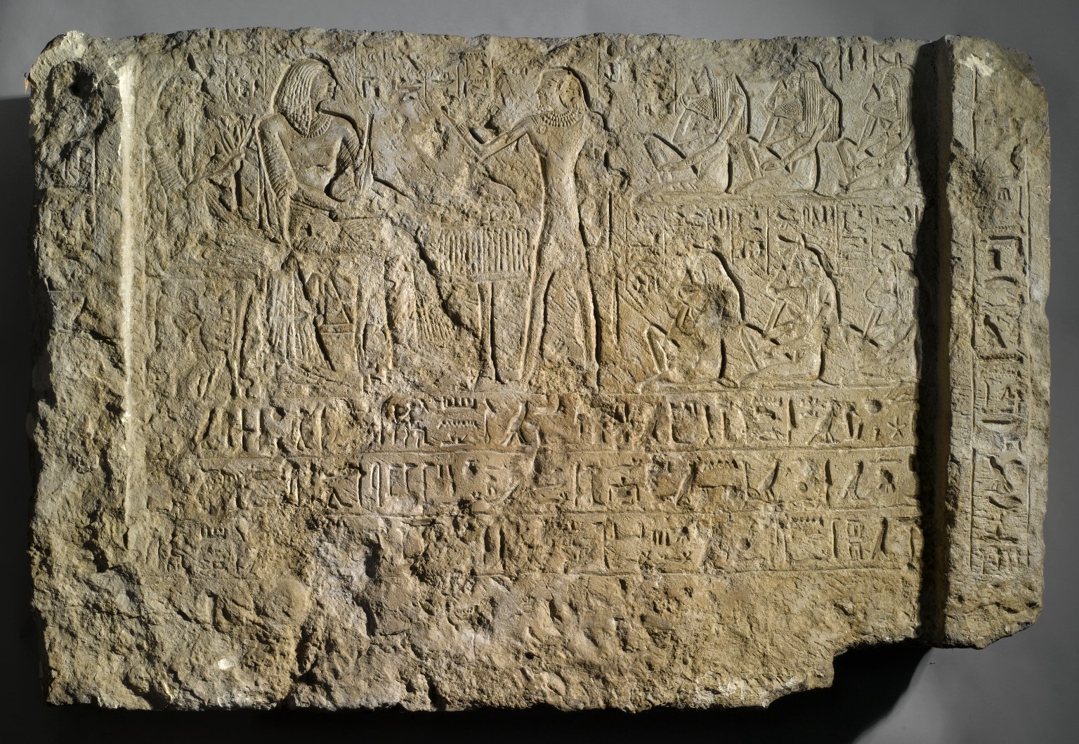 Relief of Khamwasemen and His Wife Seated at the Table of Offerings with Standing Priest
