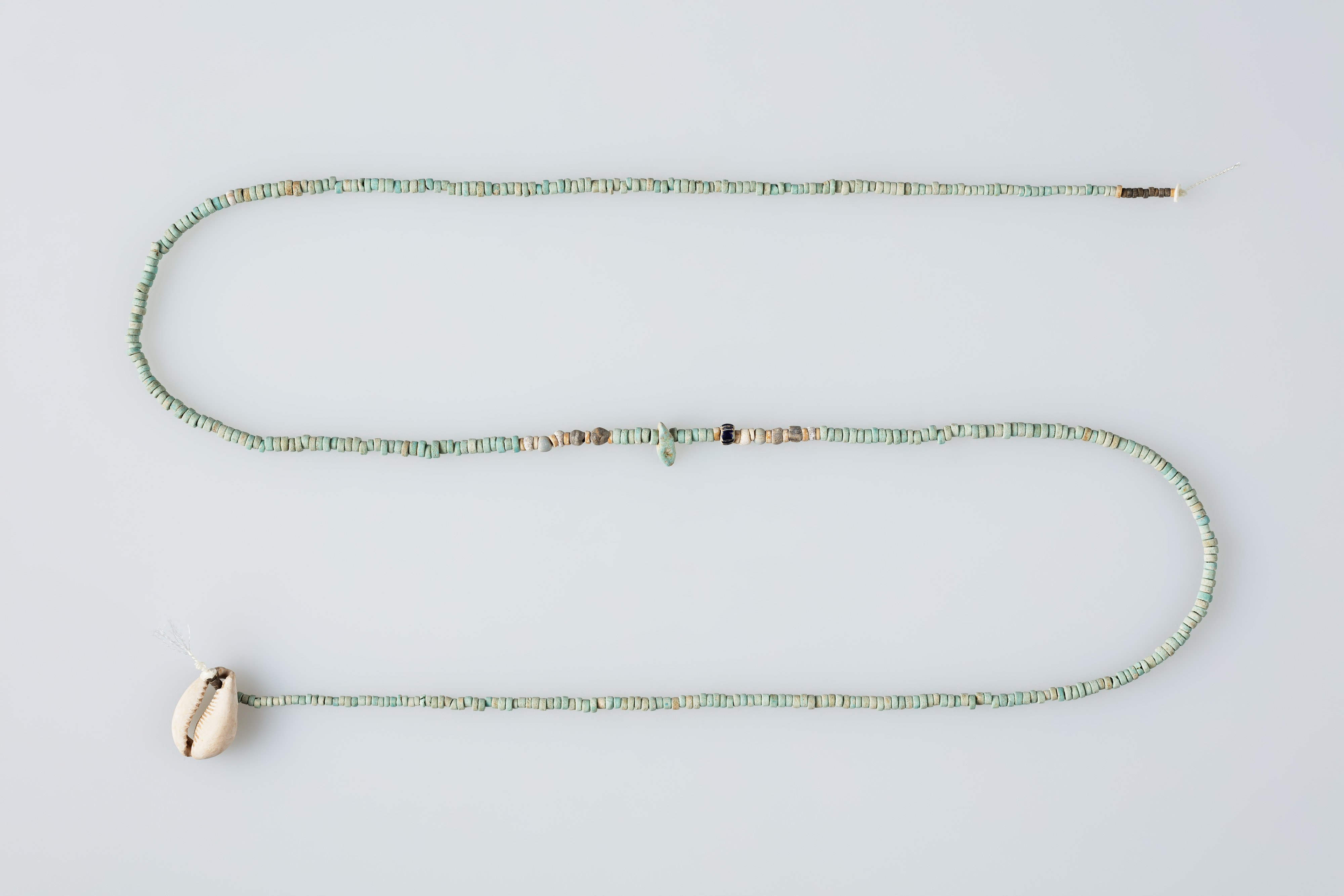 String of beads with shell pendant