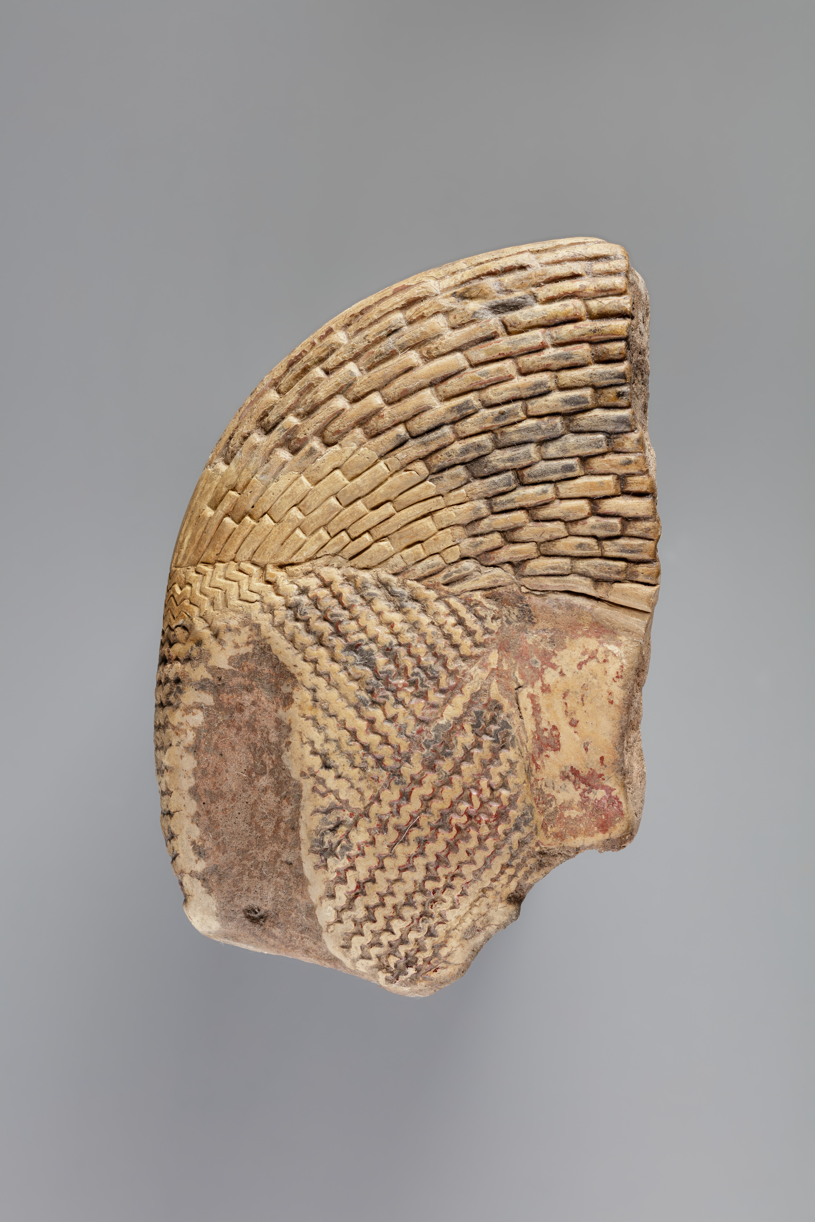 Tile fragment, part of a wig from a figure of the king