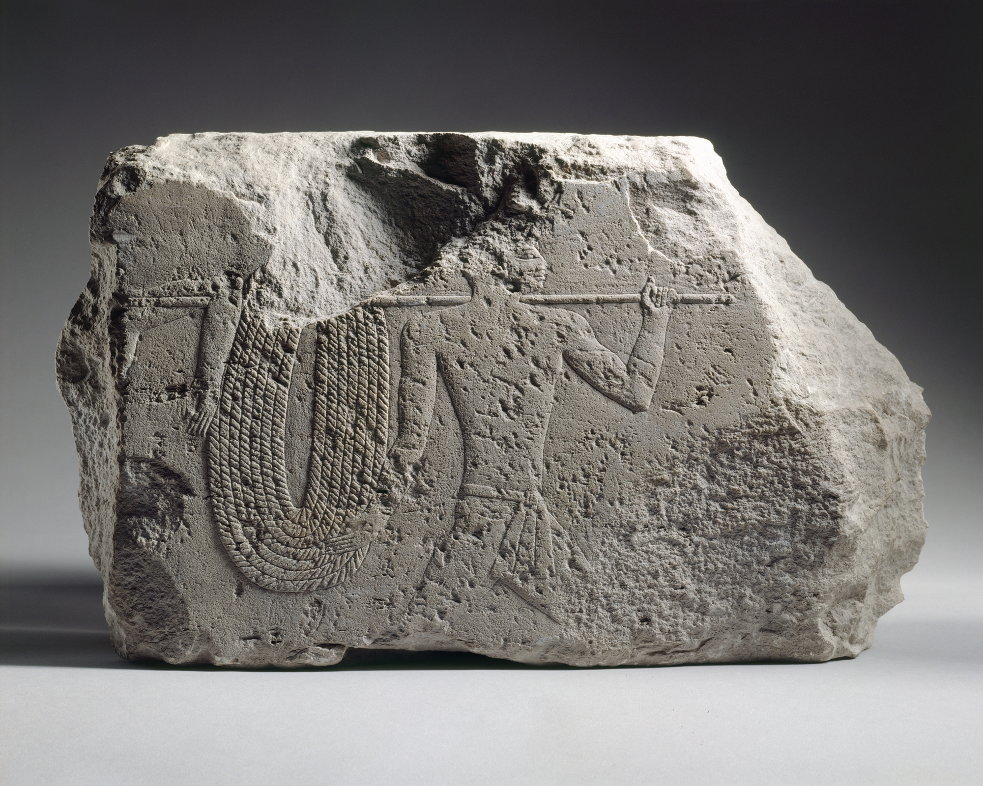 Relief fragment with soldiers running with a rope