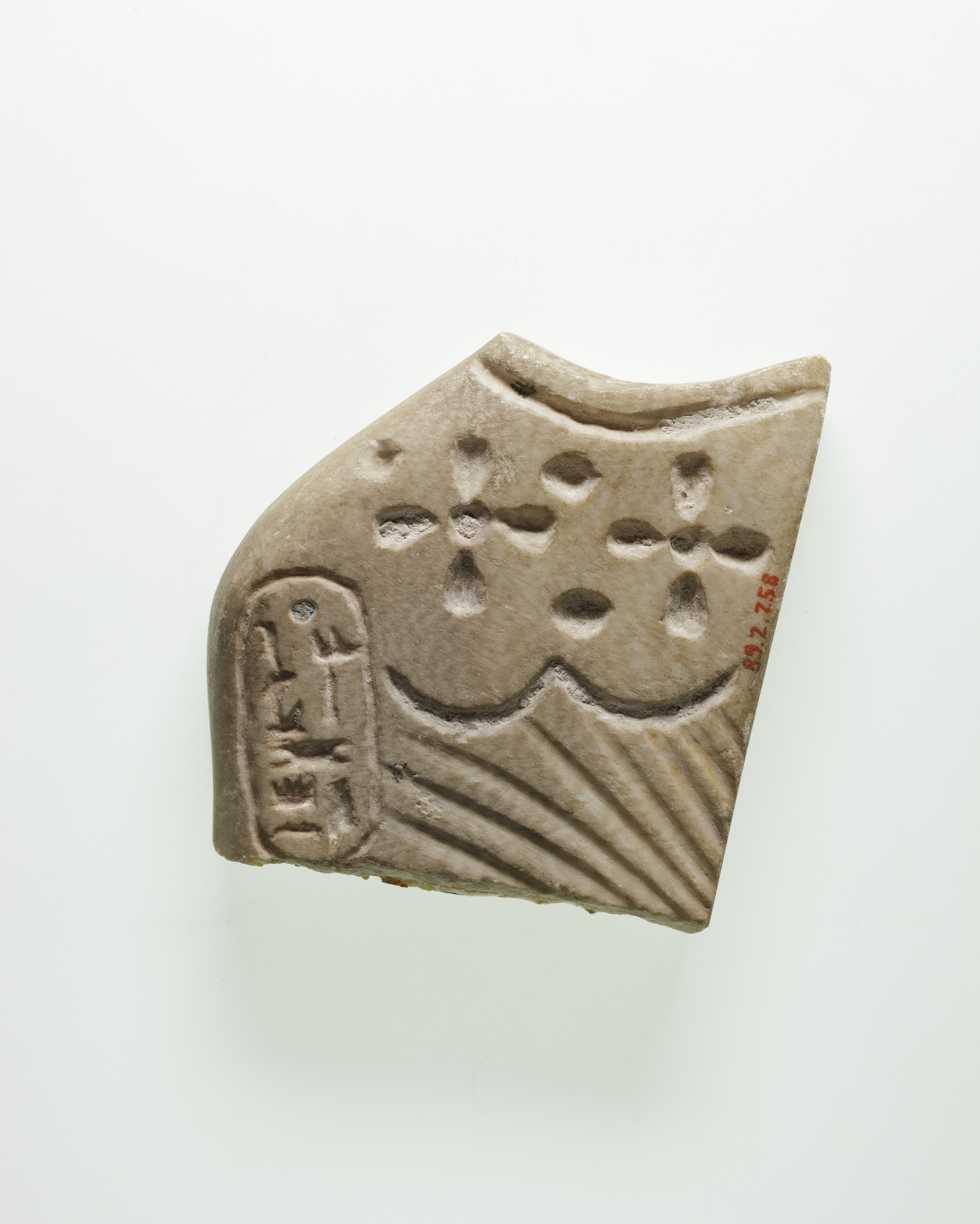 Shoulder fragment of a figural tile, with the cartouche of Ramesses III